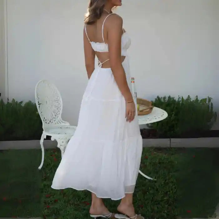 Dress with back cutout and tie strap detail in white maxi length, viewed from behind.