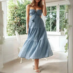  Dress in soft blue with tiered skirt and cutout sides, worn with heels indoors.