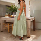 Dress in light green with open back and tied waist detail in a casual flowy maxi design