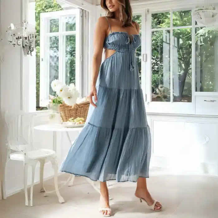 Dress in light blue with spaghetti straps, side cutouts, and relaxed tiered fit

