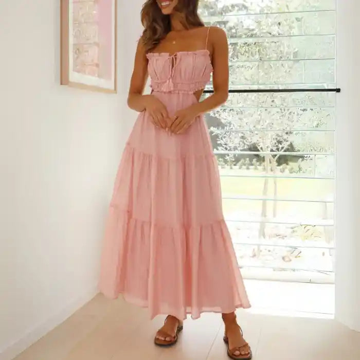 Dress in soft pink with side cutouts, spaghetti straps and tiered maxi skirt in airy fabric