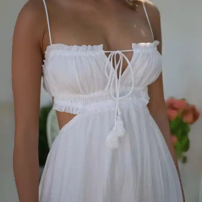 Dress closeup showing tie-front ruched bodice and white cutout detail with tassels.