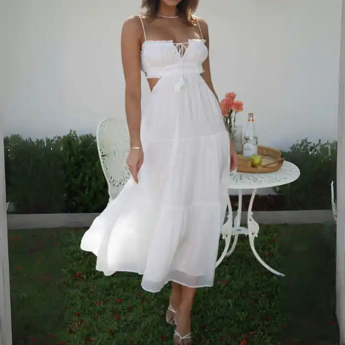 Dress with white tiered maxi cutout design, worn with heels in garden setting.