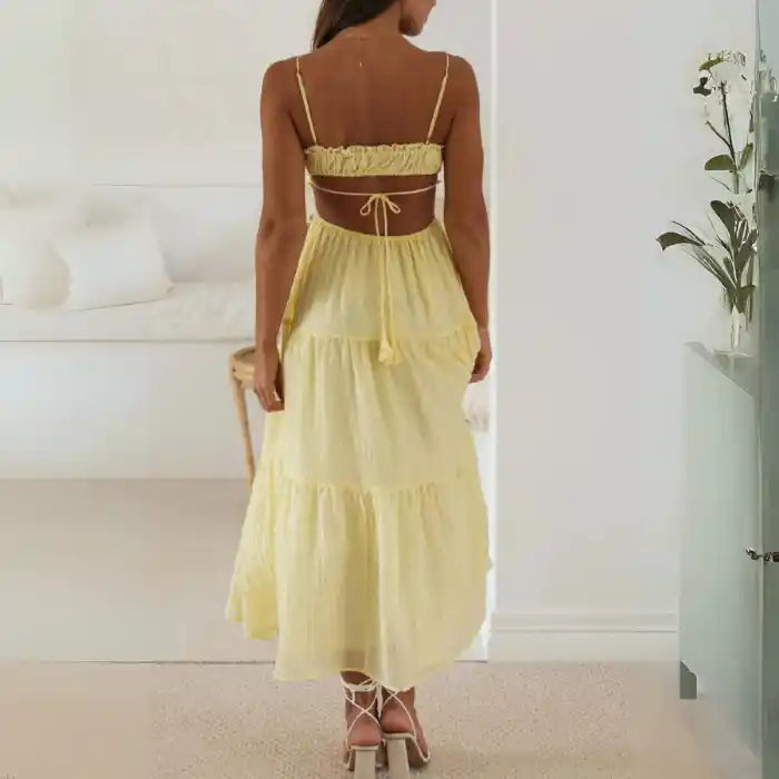 Dress in pale yellow with open back and relaxed, breezy style for warm weather

