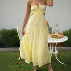  Dress in soft yellow with front tie, side cutouts, and airy summer-ready design