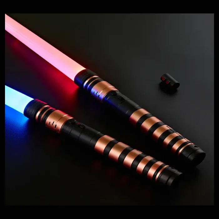 Two light swords with glowing red and blue blades, copper and black handles, displayed with a detachable connector on a black background.