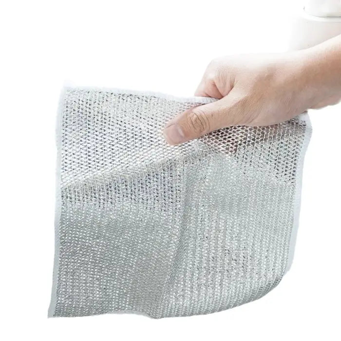 hand holding a durable silver mesh dish cloth, showcasing its lightweight and flexible design for effective cleaning.