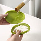 easy clean produce storage container being rinsed with water showing transparent membrane and green protective shell