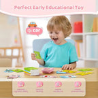 Young boy excitedly using educational flashcard reader to learn vocabulary words with sound and visuals.