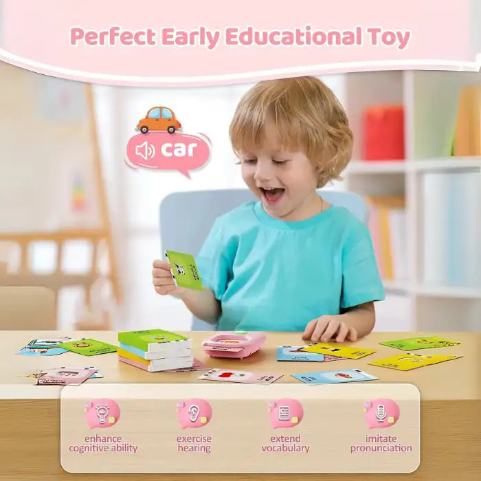 Young boy excitedly using educational flashcard reader to learn vocabulary words with sound and visuals.