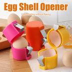 Egg shell opener in pink, orange, and yellow with eggs showing compact design and sharp blade features.