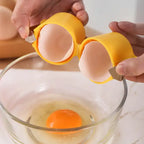 Egg shell opener splitting eggshell cleanly into two halves above glass bowl with visible yolk.