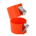 Orange egg shell opener fully opened showing stainless steel cutting blades and internal space.