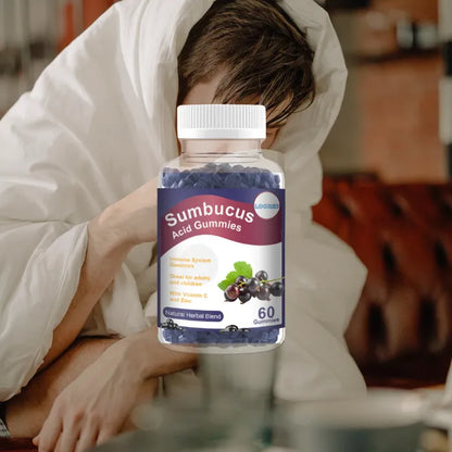 Sumbucus Acid Gummies bottle for cold relief featuring a person wrapped in a blanket for seasonal wellness.