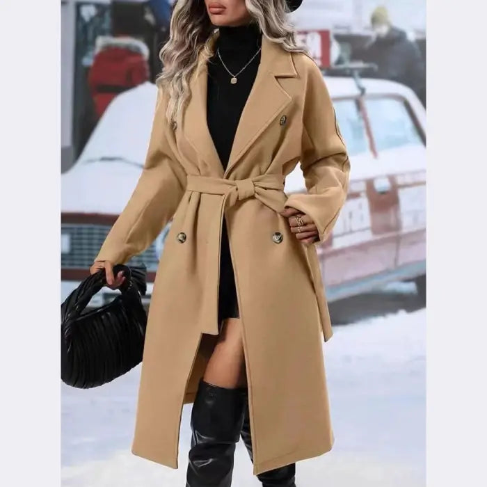 Stylish camel wool trench coat with belt tie, double-breasted buttons, and lapel collar worn with black boots and handbag