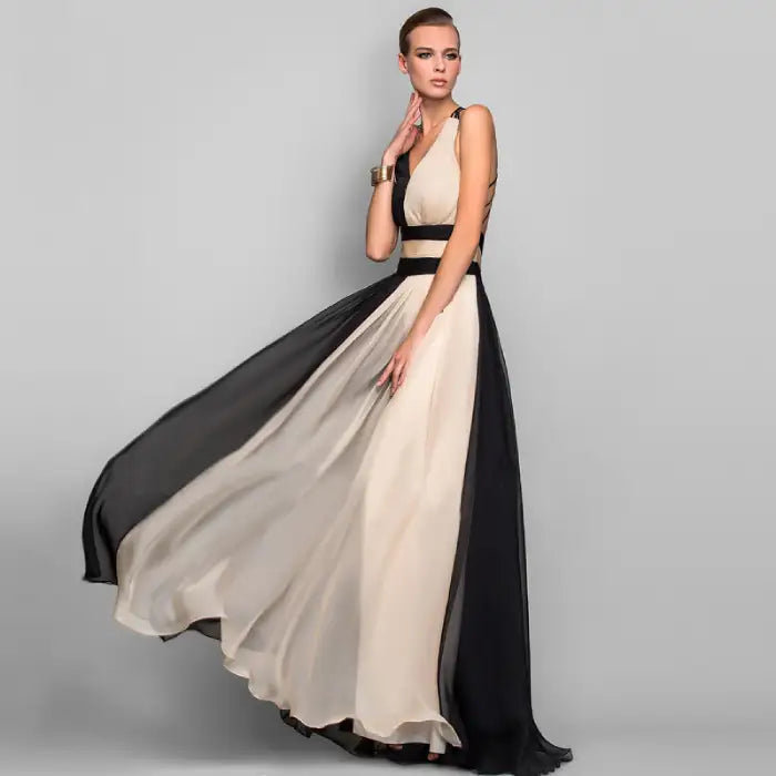 Model showcasing an elegant black and cream two tone dress with a deep V-neck and flowing skirt. Buy this affordable evening dress online for your next formal event.