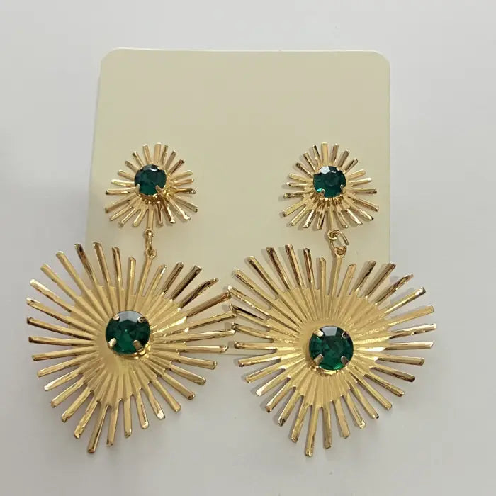 emerald sunburst statement earrings in gold presented on display card with bright green crystals and radiant, dramatic sunburst pattern
