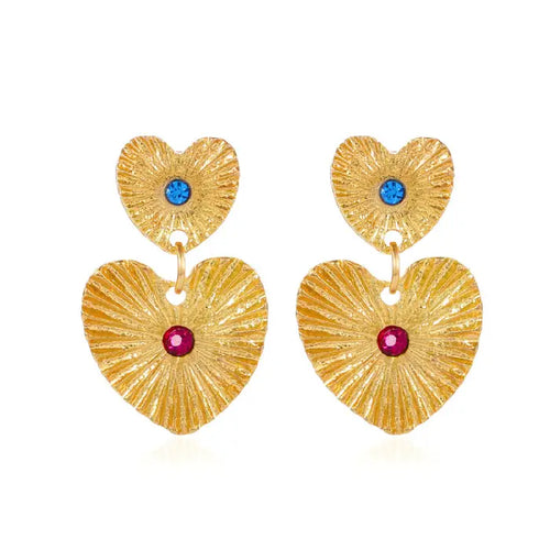emerald sunburst statement earrings shown as gold heart shapes with bright crystals, offering a bold geometric style for elegant looks