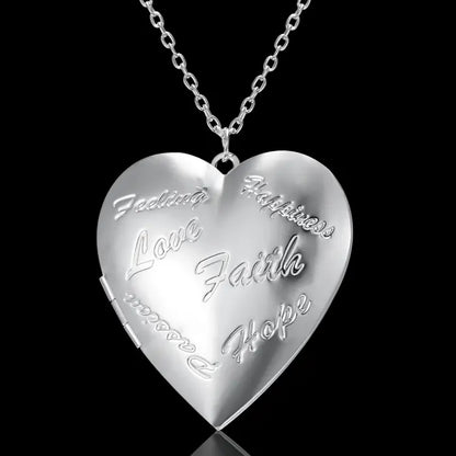 Silver heart-shaped locket with engraved words like "Love," "Faith," and "Hope," ideal for meaningful jewelry.