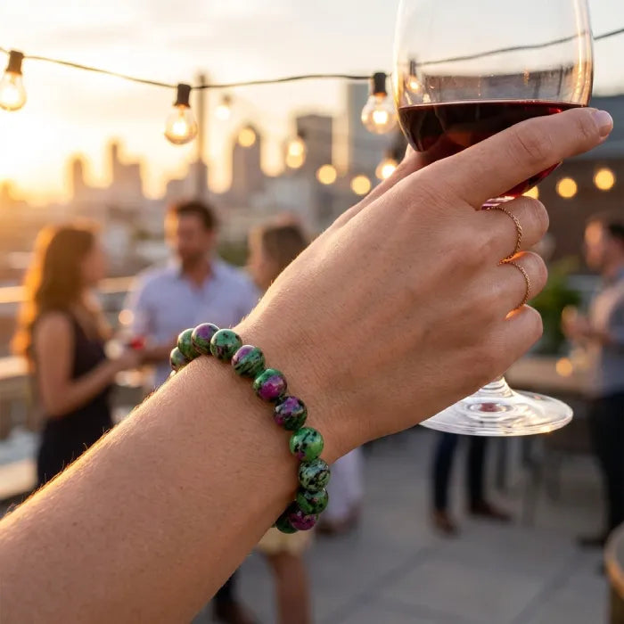 epitode bracelet worn on wrist holding wine glass at sunset, vibrant gemstone accessory for elegant lifestyle and social occasions