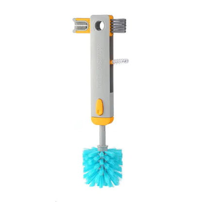  Close-up of gray cleaning brush with turquoise bristles, yellow accents, and ergonomic handle design