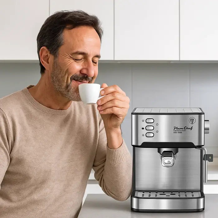 Man enjoying coffee made by espresso machine stainless steel with steam wand in modern kitchen.