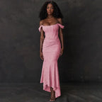 Evening dress in soft rose featuring asymmetric off-shoulder design, gathered waist detail and elegant trumpet silhouette with high-low hem