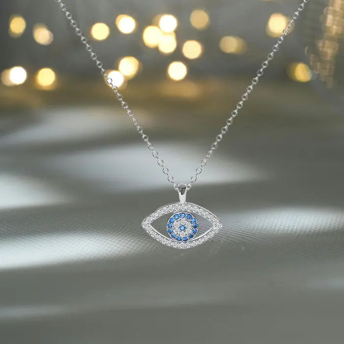 Evil eye protection necklace with shimmering blue stones photographed under glowing lights for luxury look.