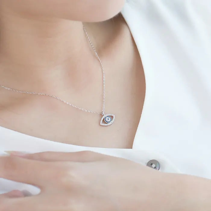 Evil eye protection necklace with blue stone pendant worn on woman’s neck for elegant everyday style.