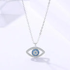 Evil eye protection necklace in sterling silver with blue crystal center and delicate chain.