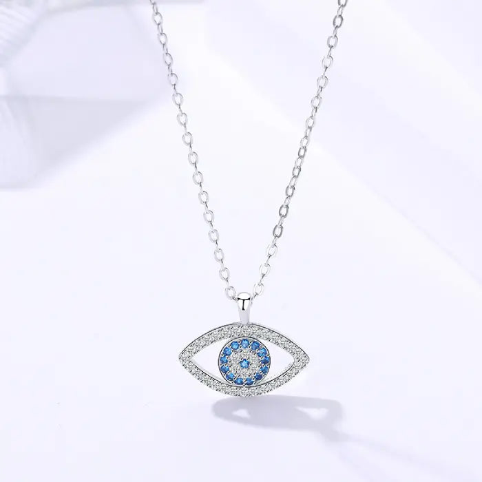 Evil eye protection necklace in sterling silver with blue crystal center and delicate chain.
