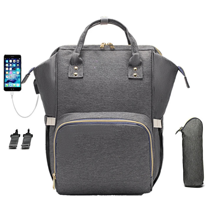 Multi-functional grey diaper bag with charging system, wide opening design and stroller attachments for tech-savvy parents