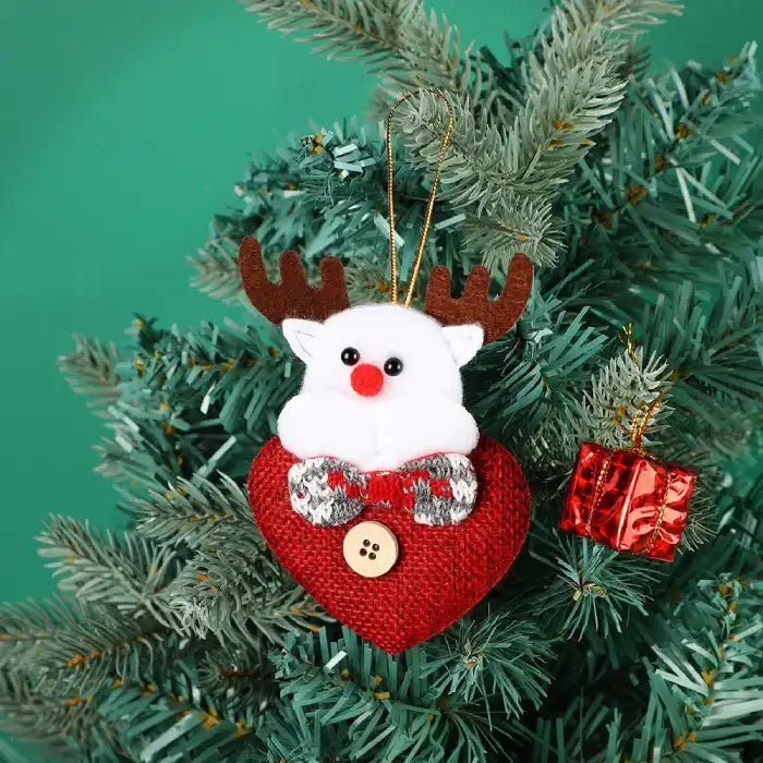 fabric pendant santa claus heart shaped white reindeer ornament hanging on christmas tree with red gift