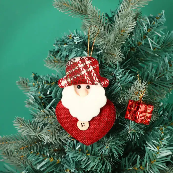 fabric pendant santa claus heart shaped santa ornament hanging on christmas tree with red gift box