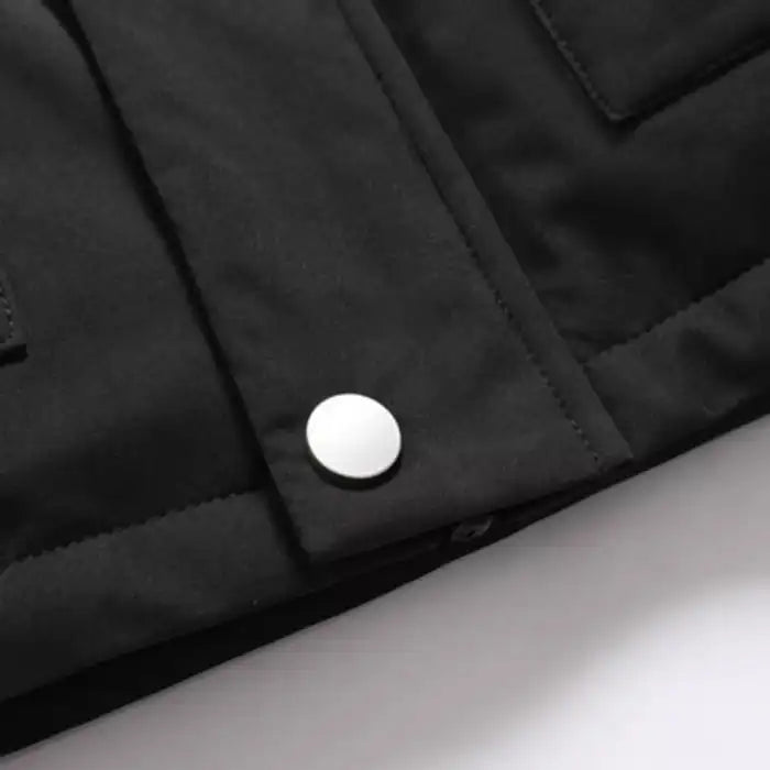 Faux fur hooded winter parka jacket pocket detail, featuring metal snap closure on utility flap.