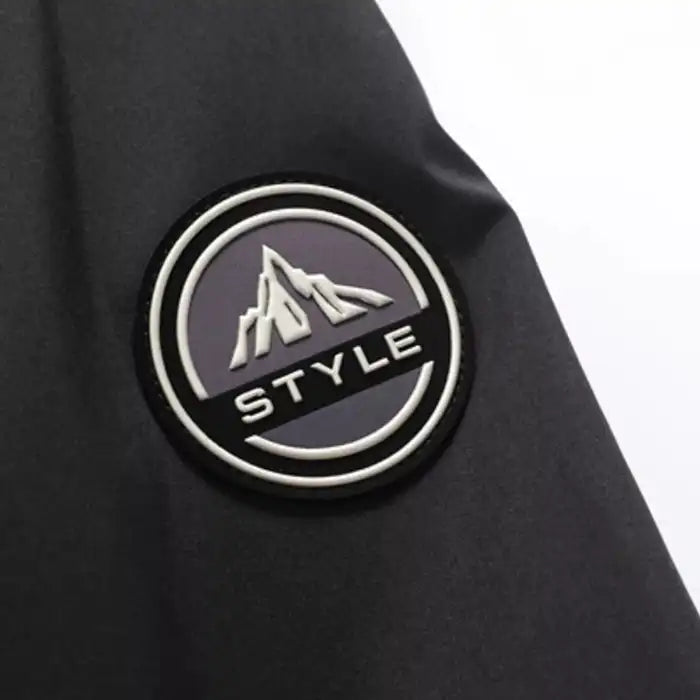  Faux fur hooded winter parka jacket sleeve badge, displaying mountain logo patch on arm closeup.