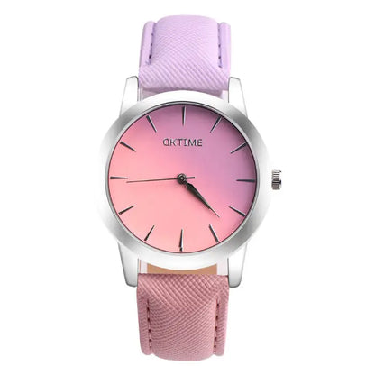 Stylish women's watch with pink to purple gradient face, silver case, and lilac leather band