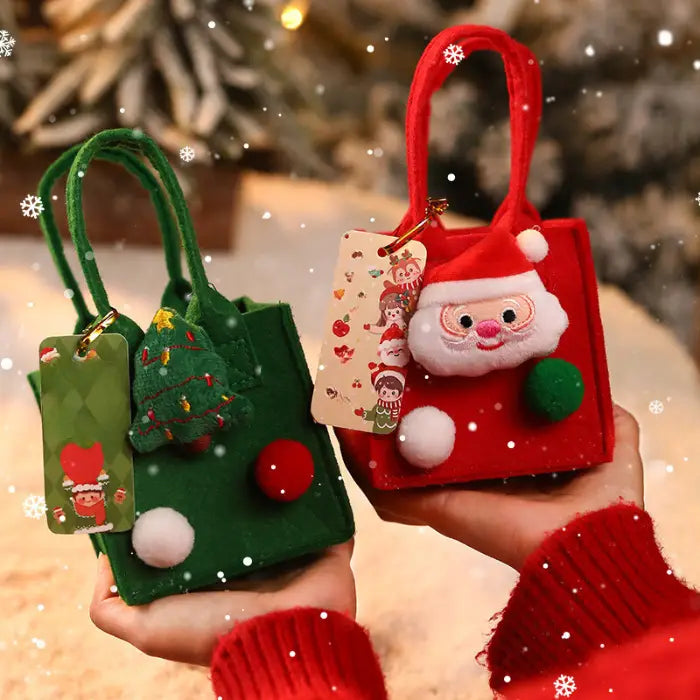 Pair of Christmas gift bags in red and green with Santa and tree ornaments, pom-poms, and holiday tags.