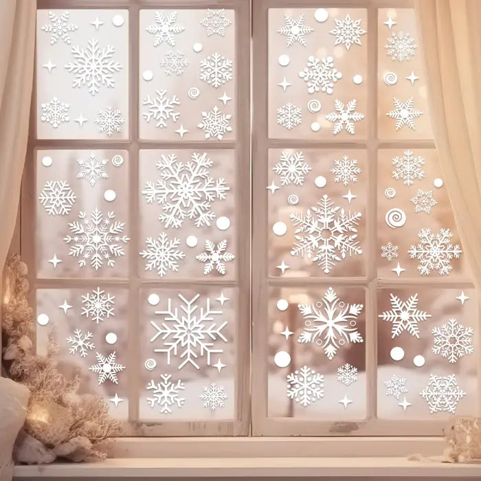Festive Christmas Window Decals with assorted snowflake stickers on frosted glass in a warm indoor setting.