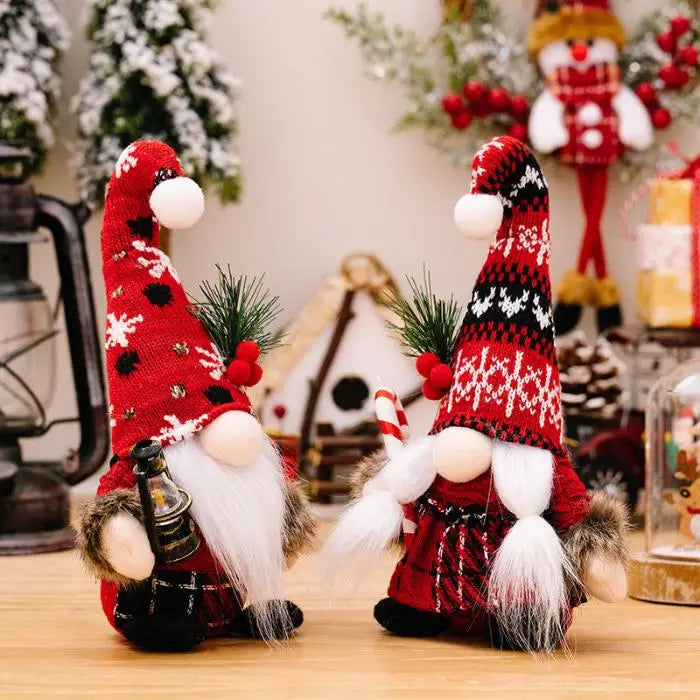 Festive gnome duo with contrasting red hats, one holding a lantern and the other a candy cane, amidst holiday decorations