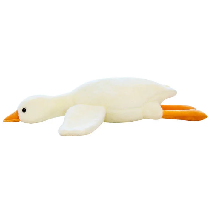 Flat lying white duck plush toy with orange beak and feet.