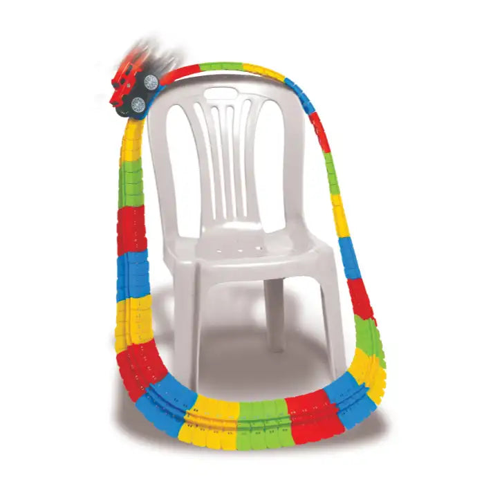 Flexible Racing track looping over a white plastic chair with red car climbing upward at speed.