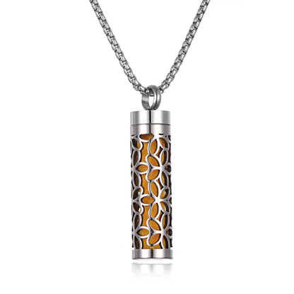 Stainless steel aromatherapy pendant with floral cutout design and orange insert for essential oils.