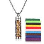 Floral design stainless steel aromatherapy pendant with yellow felt pad for essential oil diffusion.