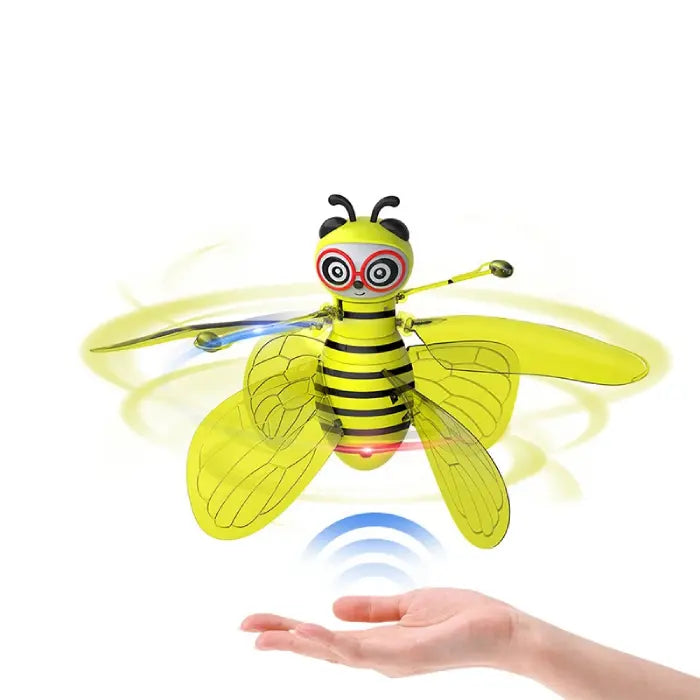 Yellow robotic bee toy with transparent wings demonstrating hovering capabilities using infrared sensor technology for motion control