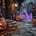 Flying witch yard decor floating near spooky porch with carved pumpkins and dry leaves.