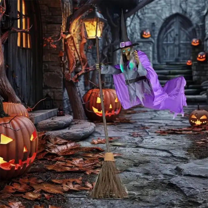 Flying witch yard decor floating near spooky porch with carved pumpkins and dry leaves.