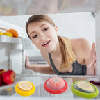 fridge storage boxes for halved produce, including avocado, tomato, and lemon, with a woman looking inside
