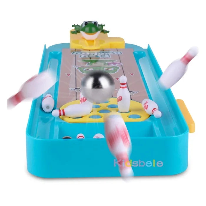 A frog-themed bowling game in action, showing pins scattering as a metallic ball rolls down the lane from the yellow frog launcher.