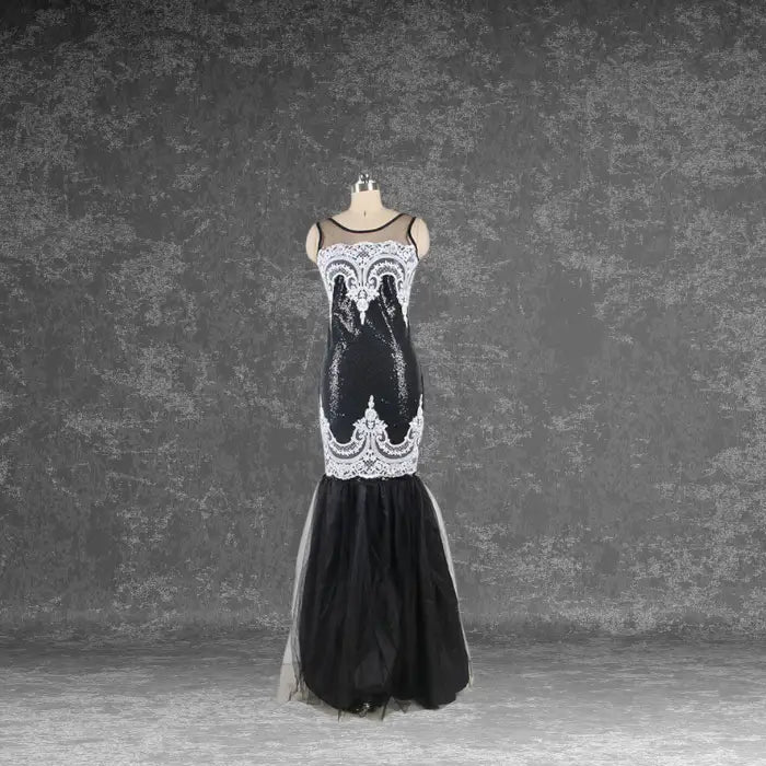 Mannequin front view showcasing the black sequin mermaid dress design with detailed white lace overlay on the bodice